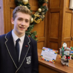 Samuel with his hand sanitising robot