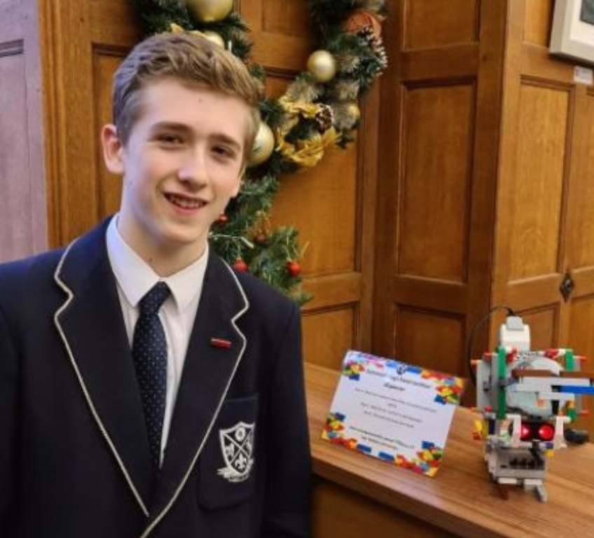 Samuel with his hand sanitising robot